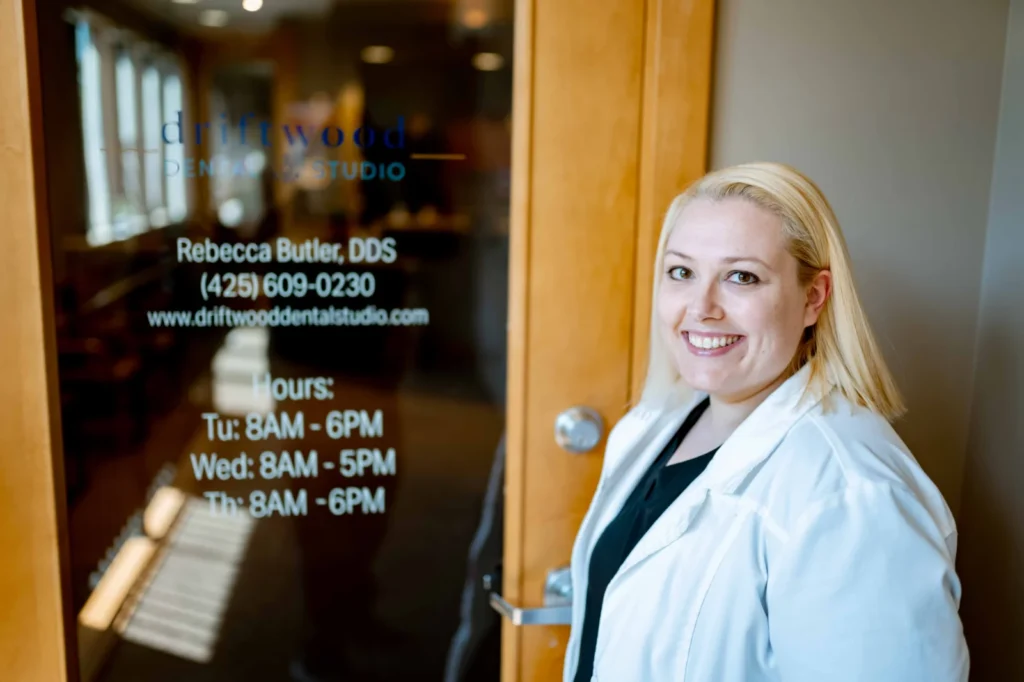 Closeup of Dr. Butler smiling outside her practice door